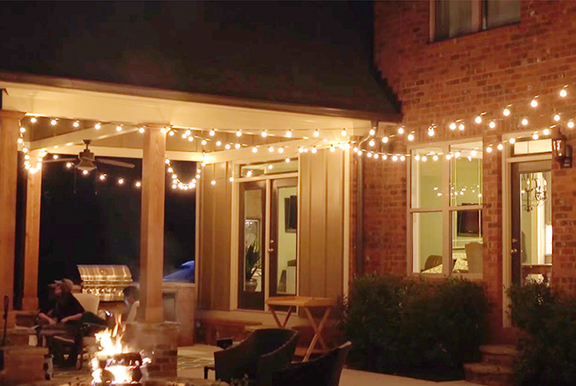 outdoor night-time look at a home patio with string lights overhead